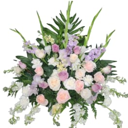 Large bouquet of pastel roses and white flowers with tall green spikes