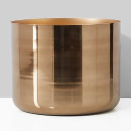 Gold metallic cylindrical vase on a plain background