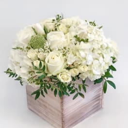 White roses and hydrangeas in a wooden box