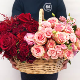Basket of red and pink roses with small filler flowers