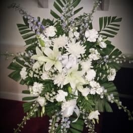 Large white floral standing spray with lilies and chrysanthemums