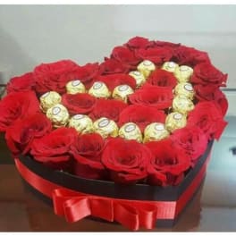 Heart-shaped box of red roses with gold-wrapped chocolates