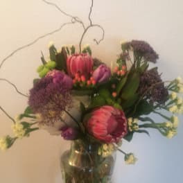 Bouquet of pink and purple flowers in a glass vase