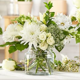 White floral arrangement in a clear glass vase