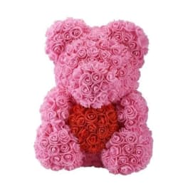Pink rose teddy bear with a red heart on a white background
