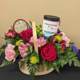 Birthday flower basket with roses, alstroemeria, and a body butter jar