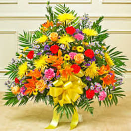 Large colorful floral spray with a yellow bow