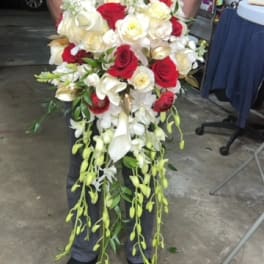 Large bouquet of red and white roses with cascading white orchids