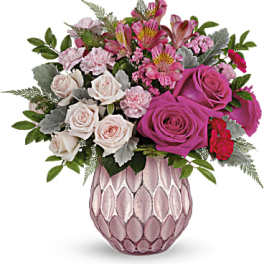 Pink and white rose bouquet in a textured pink vase