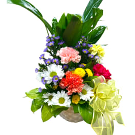 Mixed flower basket with daisies, carnations, and a yellow ribbon