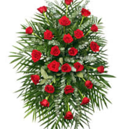Standing spray of red roses with palm fronds and greenery