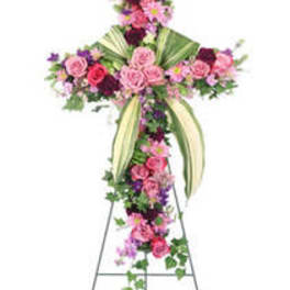Floral cross on a stand with pink and purple flowers