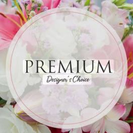 Pink and white flowers behind a circular "Premium Designer's Choice" label