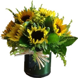 Sunflower bouquet in a dark vase with a raffia bow