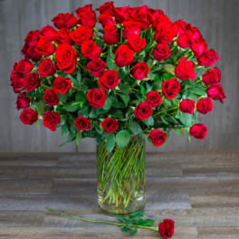 Large bouquet of red roses in a clear glass vase