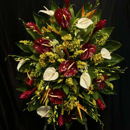 Large tropical floral spray with red and white anthuriums and yellow accents