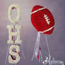 Floral football and OHS letters made of white and red flowers on stands