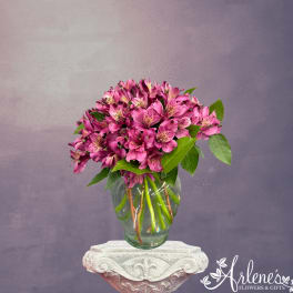 Pink alstroemeria bouquet in a clear glass vase