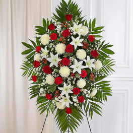 Standing floral spray with red roses, white lilies, and white mums
