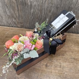 Rectangular gift box with pastel roses and a black ribbon