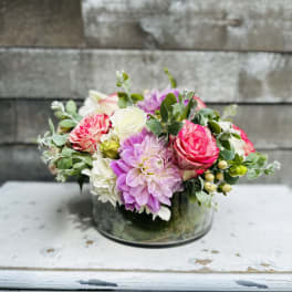 Pink and white mixed flower arrangement in a glass vase
