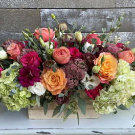 Mixed bouquet of roses and hydrangeas in a wooden box