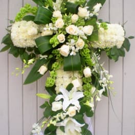 White floral cross arrangement with roses and lilies