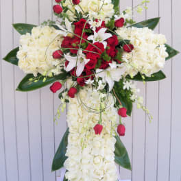 Standing floral cross with white and red roses and lilies