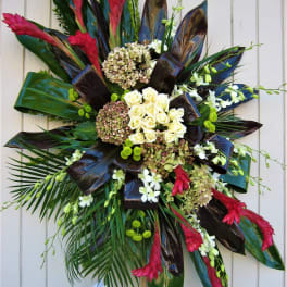 Large tropical floral spray with white roses and red blooms on a stand