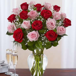 Bouquet of red and pink roses in a clear glass vase