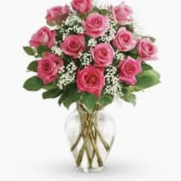 Pink roses arranged in a clear glass vase