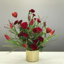 Red roses and tulips in a gold vase with glitter heart picks