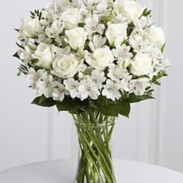 White rose and alstroemeria bouquet in a clear glass vase