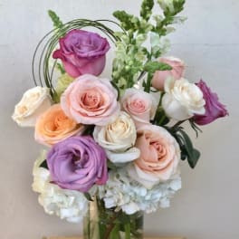 Bouquet of pastel roses in a clear glass vase