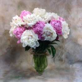 Pink and white carnations in a clear glass vase