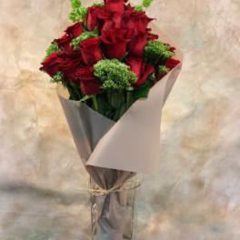 Bouquet of red roses wrapped in gray paper