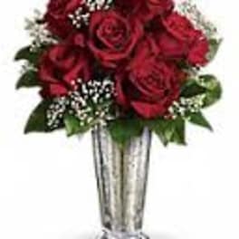 Red rose bouquet in a tall silver vase