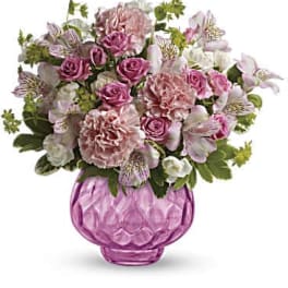Pink and white mixed bouquet in a pink glass vase