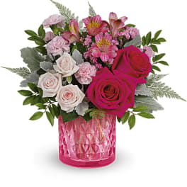 Pink and white mixed bouquet in a pink glass vase