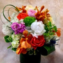 Colorful mixed flower arrangement in a black vase