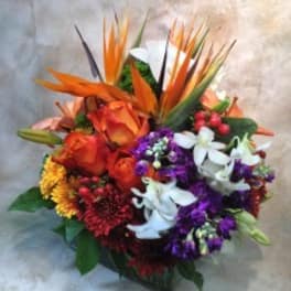 Colorful tropical bouquet with orange roses and white orchids