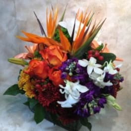 Tropical bouquet with orange birds of paradise and mixed flowers