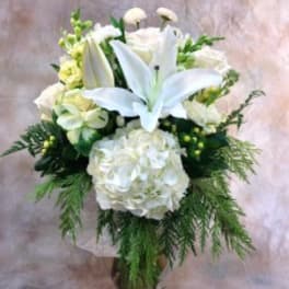 White lilies and hydrangeas in a glass vase