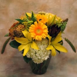 Yellow and orange flower arrangement in a dark vase