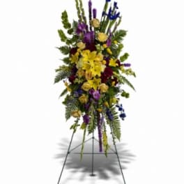 Tall standing floral spray with yellow, purple, and blue flowers