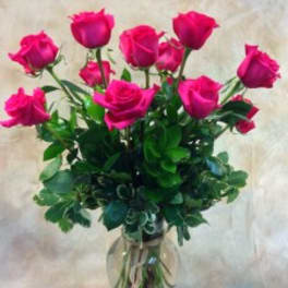 Bouquet of hot pink roses in a clear glass vase