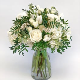 White rose bouquet in a clear glass vase
