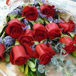 Bouquet of red roses with purple filler flowers