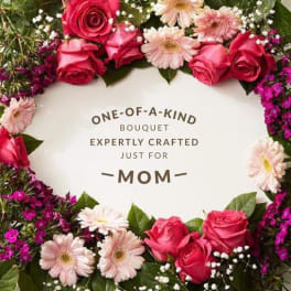 Pink roses and pale daisies arranged around a Mother's Day message