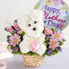 White teddy bear floral arrangement in a basket with a Mother's Day balloon